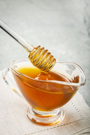 Honey in glass bowl on the table.
