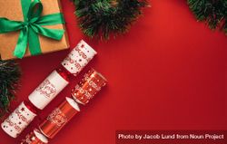 Christmas gifts and garland lying against red background 5ljLNb
