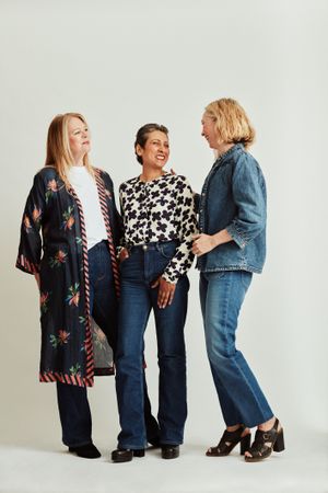 Three women standing together and smiling