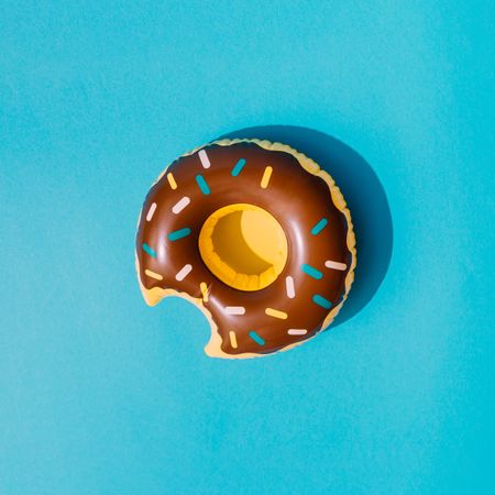 Inflatable doughnut pool toy on blue background