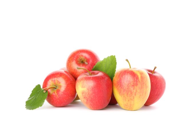 Pile of red apples isolated on light background