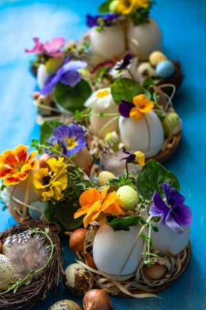 Easter holiday card concept with cute eggs and colorful delicate flowers