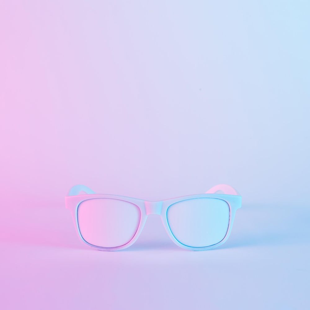 Sunglasses in vibrant bold gradient purple and blue holographic colors