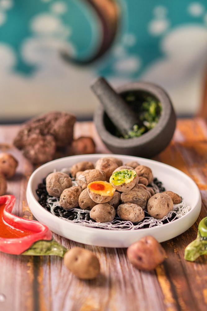 Plate of boiled potatoes near mortar and pestle