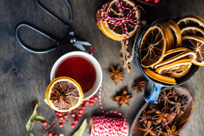 Top view close up of orange slice balancing on mug of hot tea