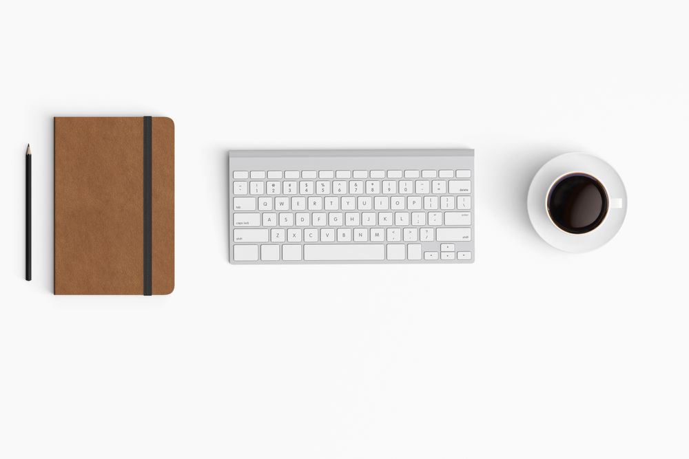 Modern workspace with coffee cup, paper, notebook