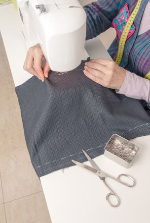 Seamstress hands working on a sewing machine