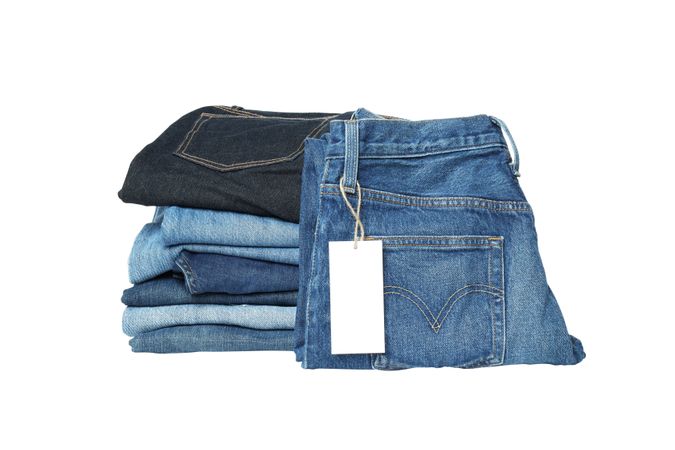 Folded jeans, isolated on light background