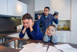 Woman feeling defeated in argument with partner in kitchen
