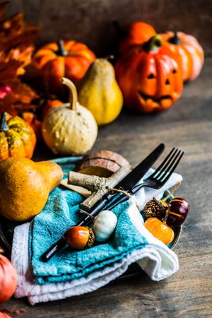 Autumnal decorations of squash and gourds on table, vertical composition