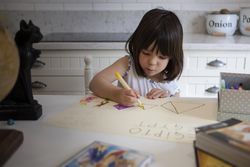 Young girl drawing at home