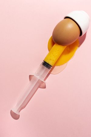 Syringe sucking yolk out of raw egg