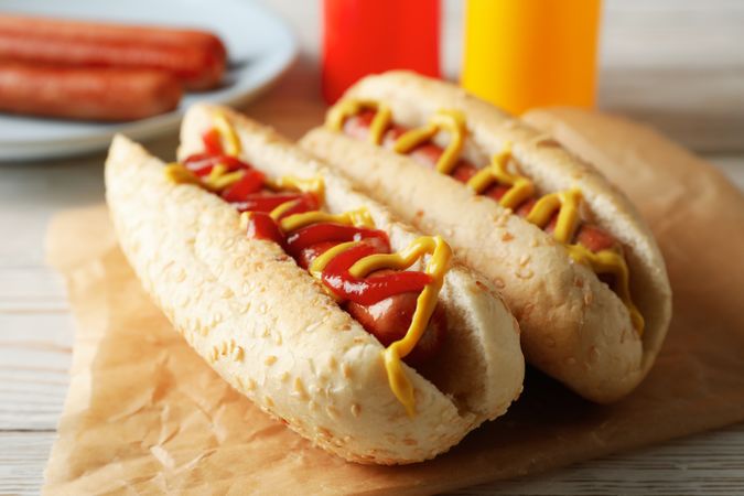 Tasty hot dogs on plain wooden rustic background