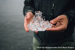 Person holding ice on cold day, landscape 43PErb