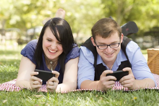 Young Couple at Park Texting Together
