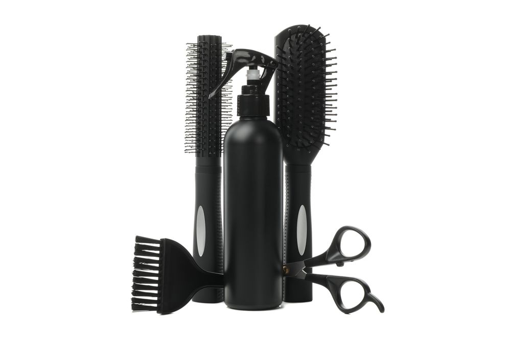 Different hairdresser accessories isolated on plain background