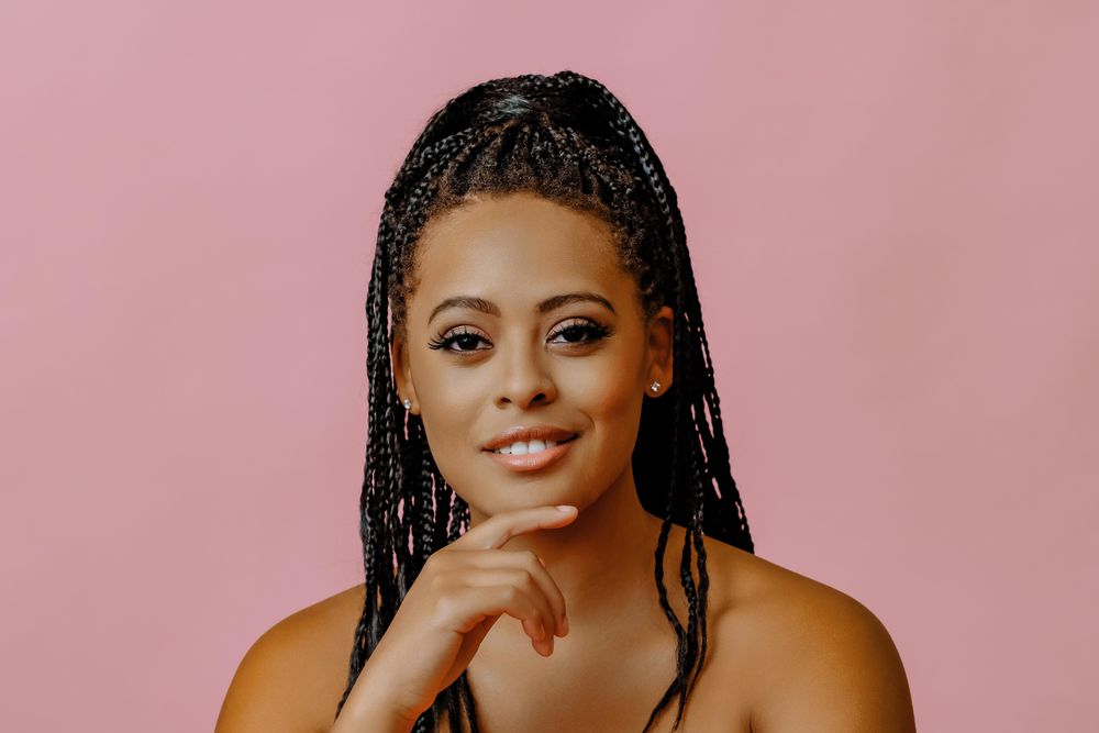 Confident female looking at camera in pink studio shoot