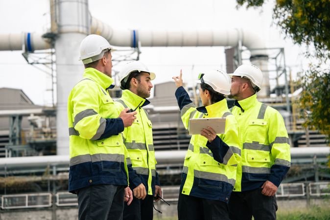 Group of engineer workers checking project at refinery oil factory
