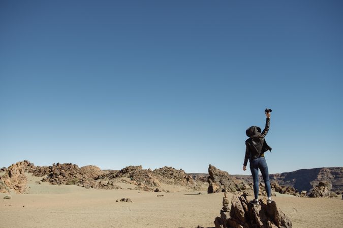 Tourist standing on top of rock