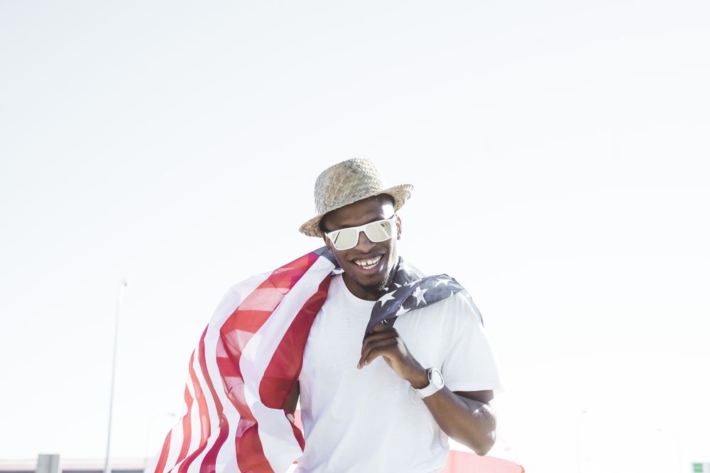 Cheerful black man with American flag