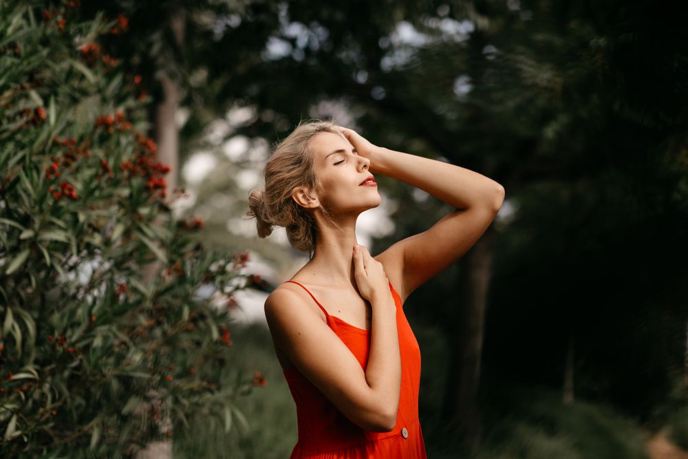 Dreamy young woman in summer garden