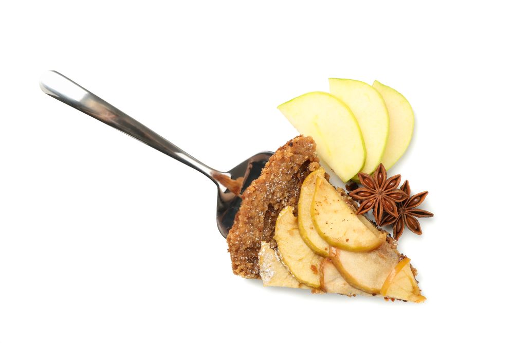 Shovel with piece of tasty apple pie isolated on plain background