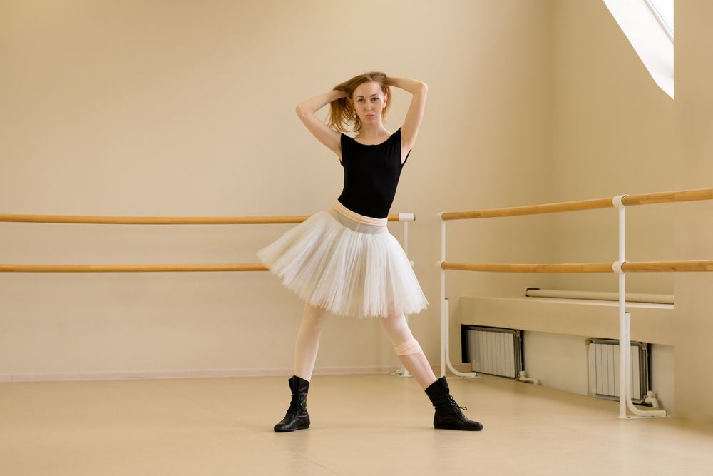 Ballerina in tutu and shoes, modern dance pose