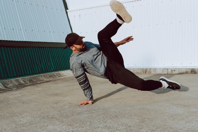 Man performing handstand near wall