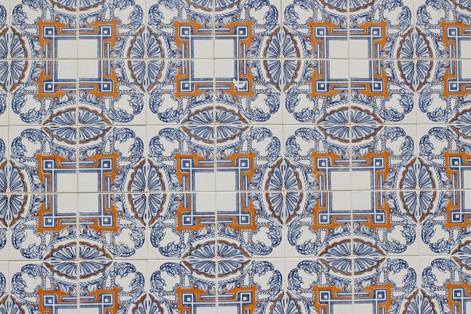 Detail of decorative floral tiles. Blue, orange ornamental traditional Portuguese ceramic tile pattern, azulejos. Beautiful facade, wall decoration of old Lisbon building. Decorative background.