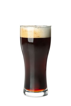 Glass of beer isolated on light background