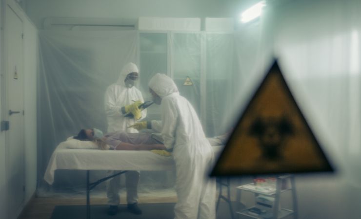 People attending to a woman with a virus lying on a stretcher