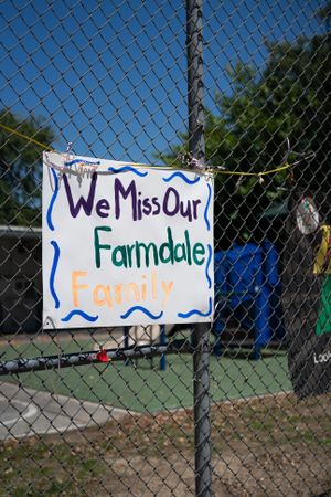 Sign taped to schoolyard fence made by teachers missing their students from school