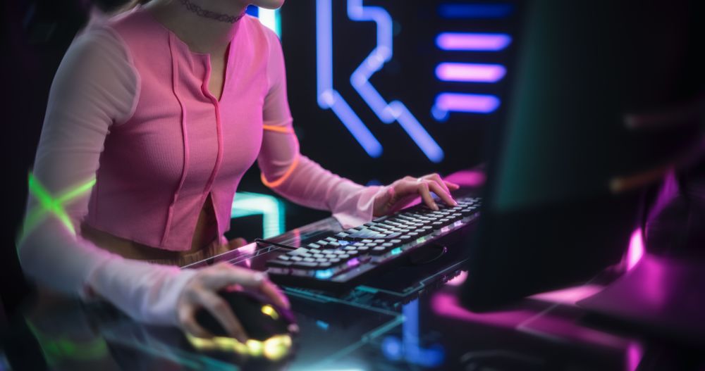 Streamer Sitting Behind a Futuristic Interactive Desk in a Colorful Neon Studio Room