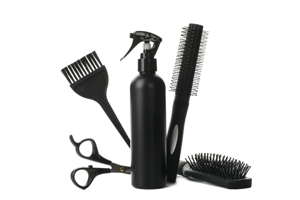Different hairdresser accessories isolated on plain background