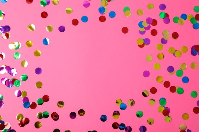 Multicolored glitter on pink background, space for text