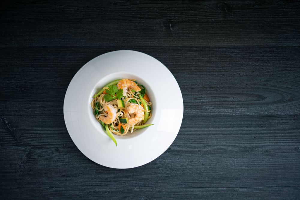 Tasty Pad Thai of vegetables and prawns in plate