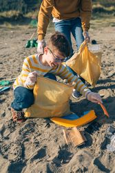 Young volunteers cleaning the beach