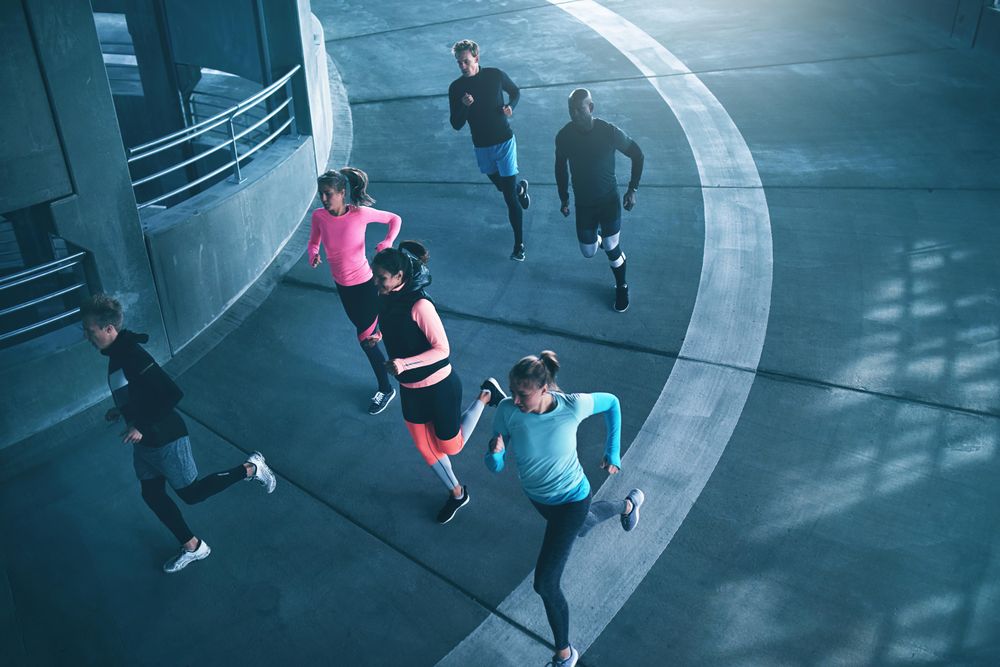 Top view of people running on cement track