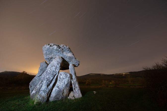 Ancient dolmen against night sky