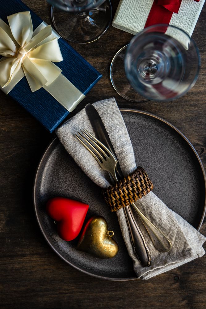 Grey plate with heart decorations and silverware