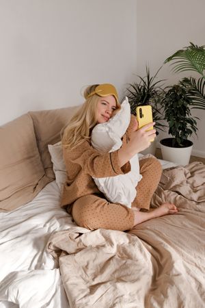 Woman in bed with phone