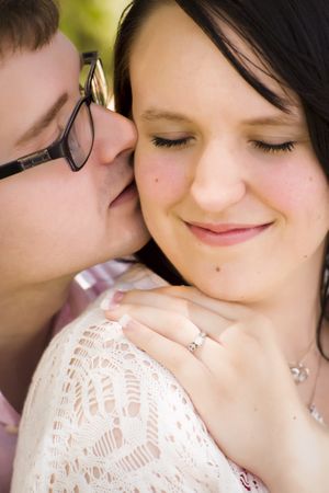 Young Engaged Couple Sharing a Moment in the Park