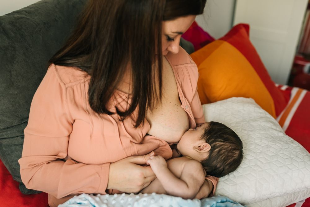 Mom breastfeeding at home