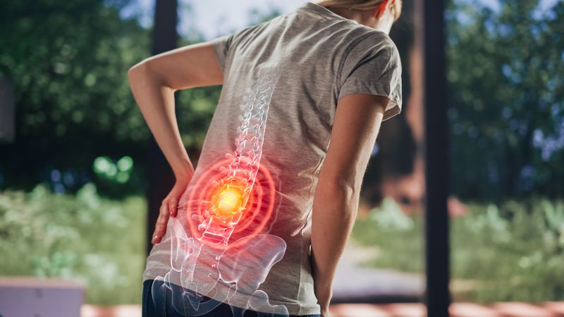 VFX Back Pain Augmented Reality Render. Close Up of a Female Experiencing Discomfort in a Result of Spine Trauma or Arthritis.