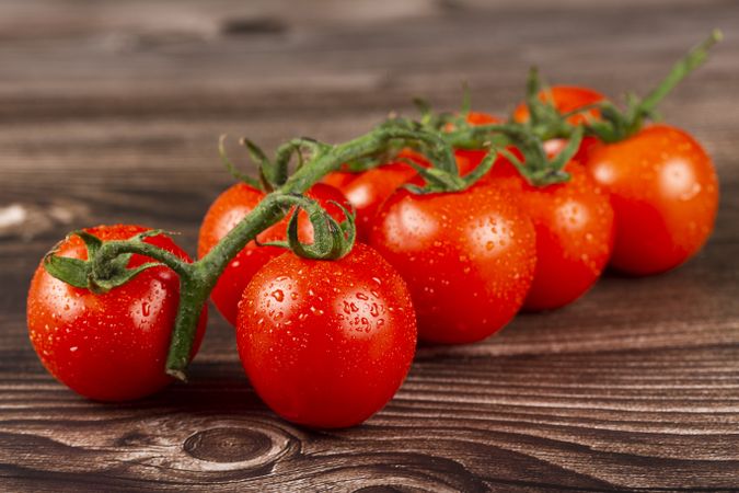 Ripe tomatoes on the wooden table.