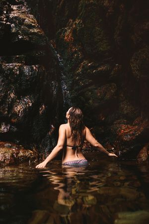 Female enjoying waterfall pond