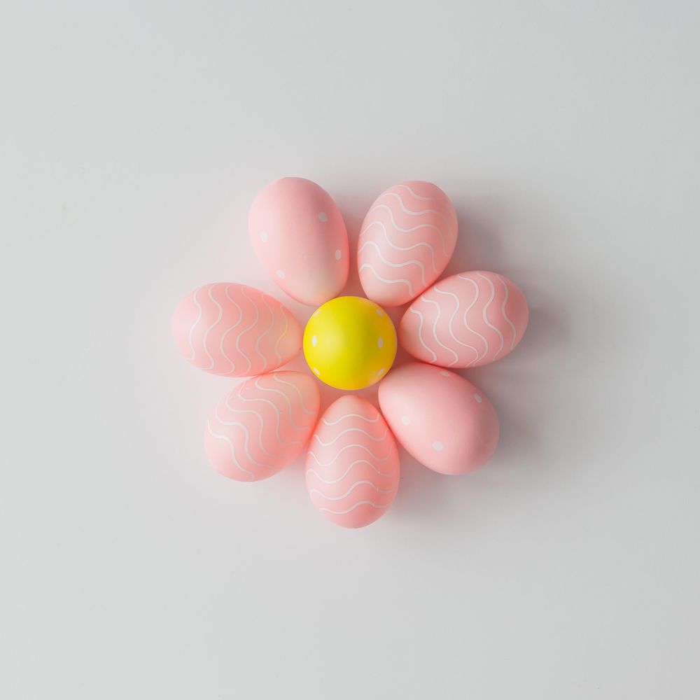 Pastel Easter eggs in shape of flower on light background