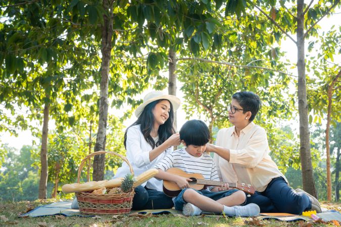 Asian family having picnic together at park on weekend