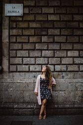 Adult woman leaning on old stone wall