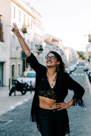 Joyful trendy female in old town street